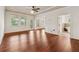 Large main bedroom with hardwood floors, neutral walls, three large windows and ensuite bathroom at 1220 State Nw St, Atlanta, GA 30318