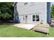 Home's backyard showing a concrete patio, some grass, and a flower bed at 2167 Tilson Rd, Decatur, GA 30032
