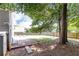 Backyard featuring a tree, grass, and a partial patio at 2167 Tilson Rd, Decatur, GA 30032