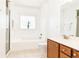 Bright bathroom featuring a shower, bathtub, and vanity with drawers and cabinets at 2167 Tilson Rd, Decatur, GA 30032