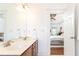 Bright bathroom with double sinks, wood cabinets, and view into the bedroom at 2167 Tilson Rd, Decatur, GA 30032