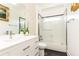 Modern bathroom with white vanity, patterned wallpaper, and shower with glass enclosure at 2167 Tilson Rd, Decatur, GA 30032