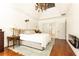 Bright bedroom with hardwood floors and neutral tones, including a fireplace and access to bathroom at 2167 Tilson Rd, Decatur, GA 30032