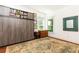 Spacious bedroom featuring built-in storage, large windows, and hardwood floors at 2167 Tilson Rd, Decatur, GA 30032
