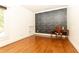 Bedroom featuring hardwood floors, desk, decorative wallpaper, and natural light at 2167 Tilson Rd, Decatur, GA 30032