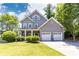 Charming two-story home with manicured lawn, two car garage, and welcoming curb appeal at 2167 Tilson Rd, Decatur, GA 30032