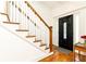 Foyer showcasing hardwood floors, white wainscoting, and a black front door with glass detailing at 2167 Tilson Rd, Decatur, GA 30032