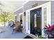 Charming front porch featuring a stylish black front door and cozy seating area, perfect for enjoying the outdoors at 2167 Tilson Rd, Decatur, GA 30032