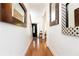 Hallway with hardwood floors, white walls, and decorative mirrors at 2167 Tilson Rd, Decatur, GA 30032