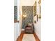 Landing area featuring hardwood floors, decorative wallpaper, a floor lamp, a leather chair, and a decorative rug at 2167 Tilson Rd, Decatur, GA 30032