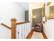 Landing area featuring hardwood floors, decorative wallpaper, and a leather chair at 2167 Tilson Rd, Decatur, GA 30032