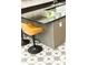 Modern kitchen island with brown leather bar stools, granite countertops and decorative star patterned tile flooring at 2167 Tilson Rd, Decatur, GA 30032