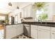 This well-lit kitchen has granite countertops, white cabinets, stainless steel appliances, and decorative star patterned tile flooring at 2167 Tilson Rd, Decatur, GA 30032