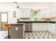 The kitchen has granite countertops, white cabinets, stainless steel appliances, and decorative star patterned tile flooring at 2167 Tilson Rd, Decatur, GA 30032