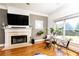 Bright living room with a fireplace, large windows, and charming decor at 2167 Tilson Rd, Decatur, GA 30032