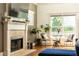 Cozy living room with a fireplace, sitting area, and large window views at 2167 Tilson Rd, Decatur, GA 30032