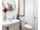 A powder room with a pedestal sink, framed mirrors, and a toilet at 2167 Tilson Rd, Decatur, GA 30032