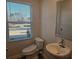 Well-lit half bathroom with a window and modern toilet with bidet features at 246 Crabapple Rd, Mcdonough, GA 30253