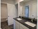 Bathroom featuring a double vanity with granite countertops, and a view of the bathroom at 246 Crabapple Rd, Mcdonough, GA 30253
