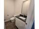 Cozy bathroom featuring a modern vanity and toilet with dark wood flooring at 246 Crabapple Rd, Mcdonough, GA 30253