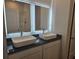 Modern bathroom featuring dual vessel sinks, black granite countertop, and sleek, backlit mirrors at 246 Crabapple Rd, Mcdonough, GA 30253