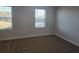 Bright bedroom featuring large windows and neutral carpet at 246 Crabapple Rd, Mcdonough, GA 30253
