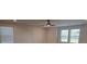 Bright bedroom featuring two windows with blind coverings and a ceiling fan with overhead lighting at 246 Crabapple Rd, Mcdonough, GA 30253