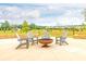Outdoor firepit and seating area surrounded by green space at 246 Crabapple Rd, Mcdonough, GA 30253