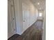 Hallway featuring dark wood flooring and white doors at 246 Crabapple Rd, Mcdonough, GA 30253