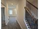 Inviting hallway showcasing stairs, and seamlessly connects to a room with bright windows at 246 Crabapple Rd, Mcdonough, GA 30253