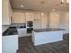 Well-equipped kitchen features stainless appliances, dark countertops and hardwood floors at 246 Crabapple Rd, Mcdonough, GA 30253