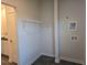A compact laundry room with wire shelving, utility sink hookups, and modern flooring at 246 Crabapple Rd, Mcdonough, GA 30253