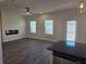 Open concept living room featuring electric fireplace, stainless steel appliances and dark wood flooring at 246 Crabapple Rd, Mcdonough, GA 30253