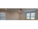 Spacious living room with ceiling fan and large windows at 246 Crabapple Rd, Mcdonough, GA 30253