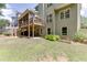 Spacious backyard featuring a covered patio, lush lawn, and landscaped garden at 3930 Suwanee Bend Dr, Suwanee, GA 30024