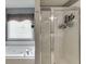 Bright bathroom featuring a soaking tub and glass enclosed shower at 3930 Suwanee Bend Dr, Suwanee, GA 30024