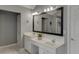 Bathroom with a double sink vanity, large mirror, and a door leading to the shower area at 3930 Suwanee Bend Dr, Suwanee, GA 30024
