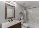 Bathroom with a framed mirror above the vanity, and a shower-tub combo at 3930 Suwanee Bend Dr, Suwanee, GA 30024