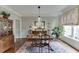 Elegant dining room with hardwood floors, chandelier, and stylish decor at 3930 Suwanee Bend Dr, Suwanee, GA 30024