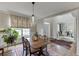 Charming dining room with hardwood floors and elegant chandelier leading into the office at 3930 Suwanee Bend Dr, Suwanee, GA 30024
