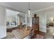 Open-concept dining room with hardwood floors, chandelier and flow into other living spaces at 3930 Suwanee Bend Dr, Suwanee, GA 30024