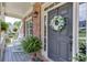 Beautiful front door decorated with a wreath, flanked by plants and featuring a cozy porch at 3930 Suwanee Bend Dr, Suwanee, GA 30024