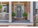 A welcoming front porch featuring decorative plants, a wreath, and inviting seating at 3930 Suwanee Bend Dr, Suwanee, GA 30024
