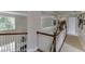 Second floor hallway with white railing and open view to downstairs area at 3930 Suwanee Bend Dr, Suwanee, GA 30024