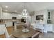 Bright kitchen features white cabinets, stainless steel appliances, island, and a breakfast nook at 3930 Suwanee Bend Dr, Suwanee, GA 30024
