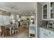 Bright kitchen features white cabinets, stainless steel appliances, island, and a breakfast nook at 3930 Suwanee Bend Dr, Suwanee, GA 30024