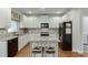 Kitchen boasts granite countertops, stainless appliances, white cabinets, and a center island at 3930 Suwanee Bend Dr, Suwanee, GA 30024