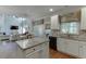 Bright kitchen open to living area, featuring granite countertops and stainless steel appliances at 3930 Suwanee Bend Dr, Suwanee, GA 30024