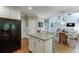 Spacious kitchen with island, hardwood floors, and an open view to the adjacent living area at 3930 Suwanee Bend Dr, Suwanee, GA 30024