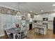 Bright kitchen features white cabinets, stainless steel appliances, island, and a breakfast nook at 3930 Suwanee Bend Dr, Suwanee, GA 30024